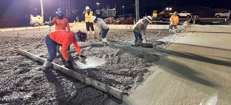 Construction crew placing concrete during the Spring Hill facility project